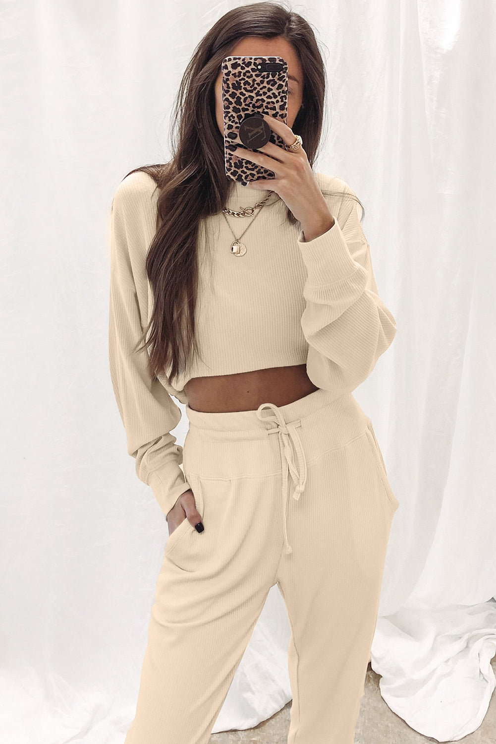 This elegant Be Lindsay - Two Piece Set features an Apricot Ribbed Long Sleeve Top and Drawstring Pants. Perfect for any occasion, it's a must-have for those who want comfort and style.