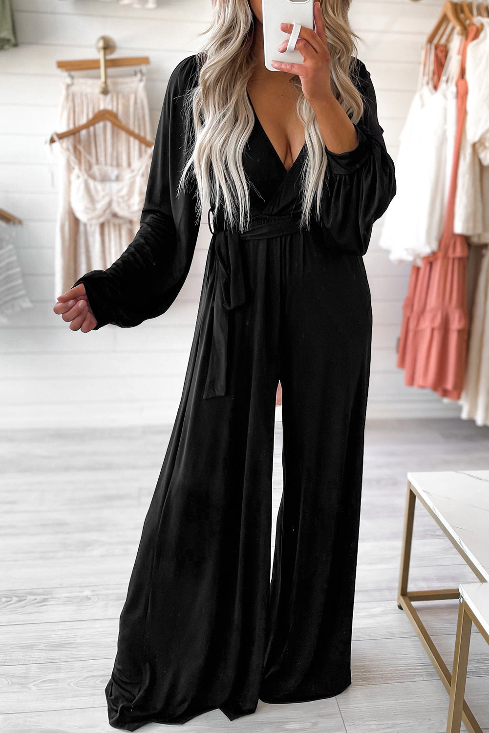 The Tejas - Jumpsuit features a sophisticated and stylish design with a deep V-cut back, perfectly accentuated with a belted waist and wide leg silhouette, making it a bold and alluring choice.