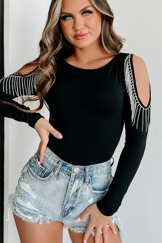 The Black Spinel Bodysuit is designed with long sleeves and a cold shoulder style, accented with fringed detailing and adorned with rhinestones. Perfect for adding a touch of glamour to any outfit.