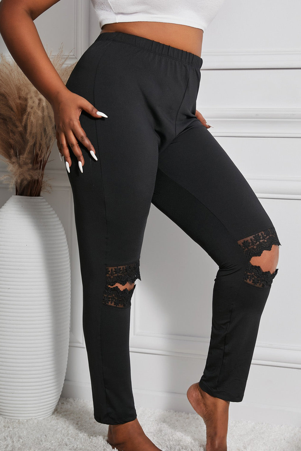 The Legacy Leggings boast a sleek and stylish design, featuring intricate black lace contrast and a unique hollow out pattern, perfect for showing off your curves while staying comfortable and on-trend.
