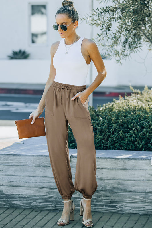 Enhance your wardrobe with Trinity - Pocket Pants, perfect for any occasion. These pants feature an elastic waist and drawstring for ultimate comfort and convenience. Whether you're heading to the office or a date night, these pants provide a versatile and stylish option.