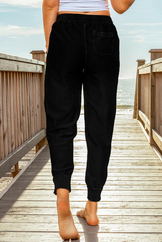 These pants offer a comfortable fit with an elastic waist and drawstring. Perfect for a casual yet professional look.