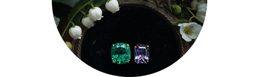Antique Emerald and Alexandrite jewelry displayed with Lily of the Valley and Hawthorn wedding flowers — Demali&RiverCo.