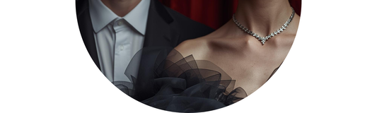 Close-up of a man and a women's diamond necklace on a couple in formal wear, styled for 2026 milestone jewelry — Demali&RiverCo Limitless Blog