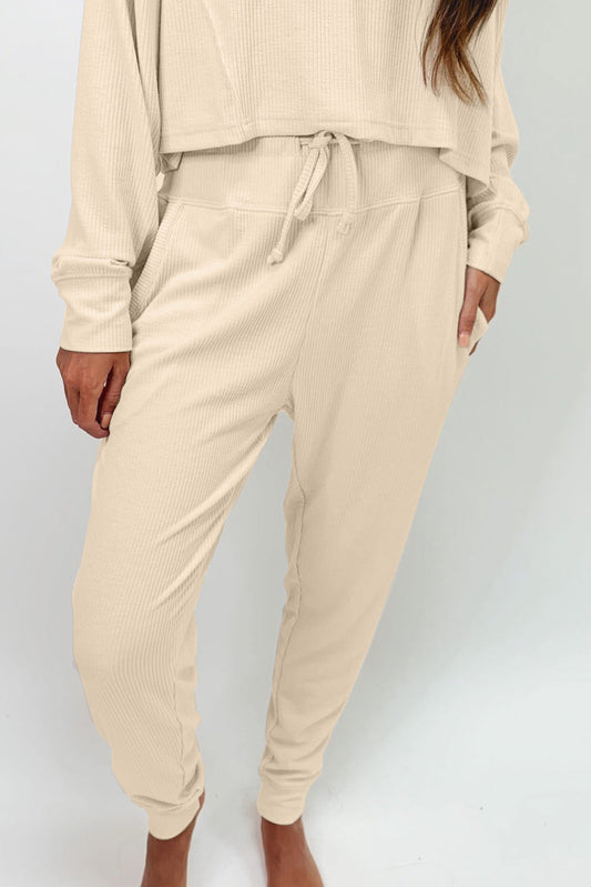 This elegant Be Lindsay - Two Piece Set features an Apricot Ribbed Long Sleeve Top and Drawstring Pants. Perfect for any occasion, it's a must-have for those who want comfort and style.